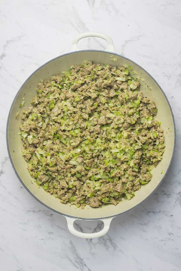 sausage meat, celery and herbs being cooked for stuffing