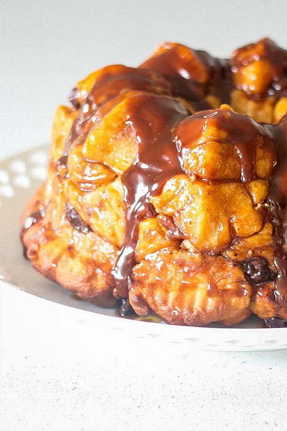 monkey bread with caramel sauce on a white serving plate