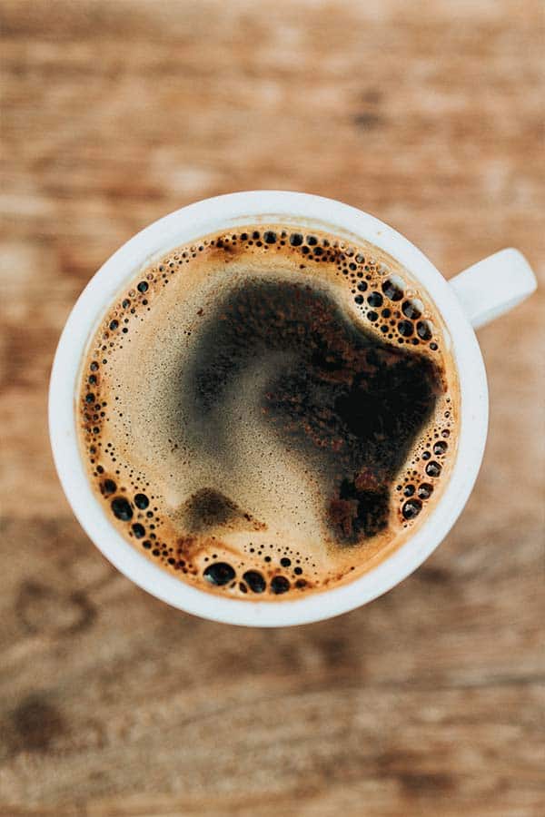 an overhead image of a cup of black coffee