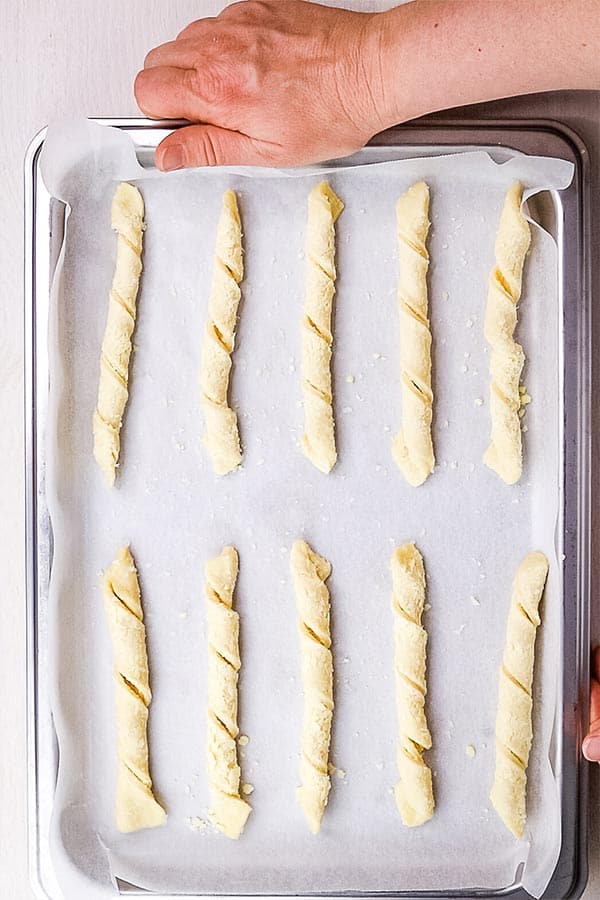a sheet pan of unbaked cheese straws