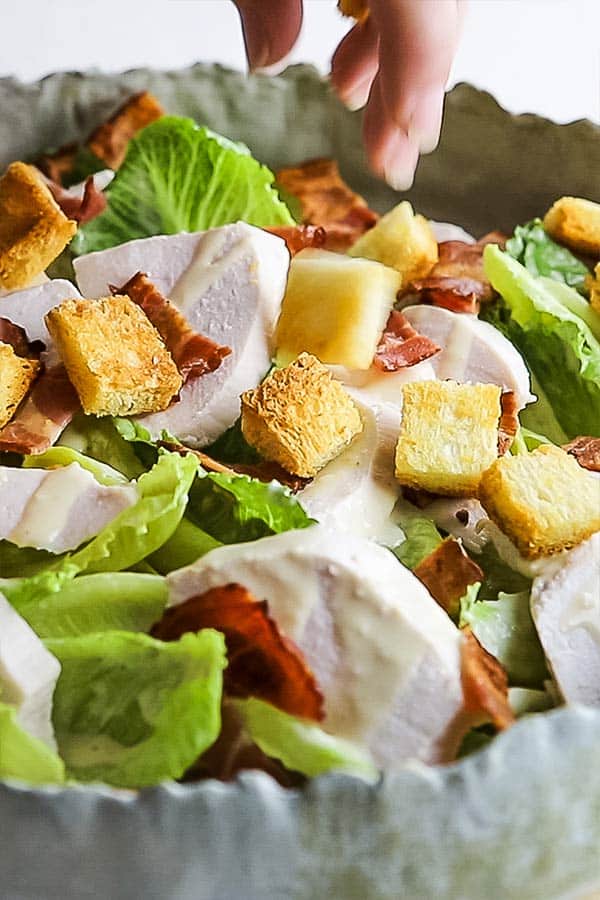 caesar salad being assembled