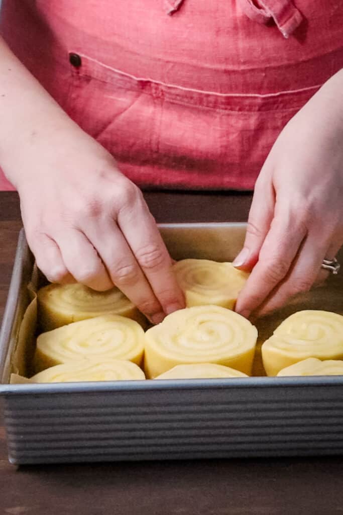 putting lemon rolls in a pan