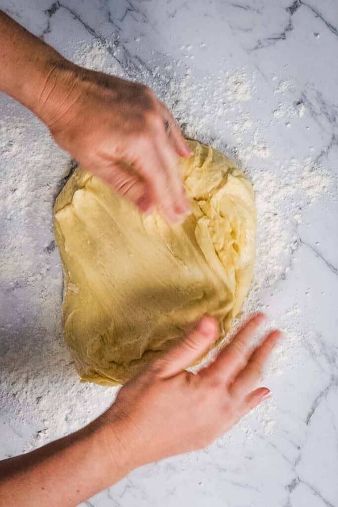 stretching dough on a countertop