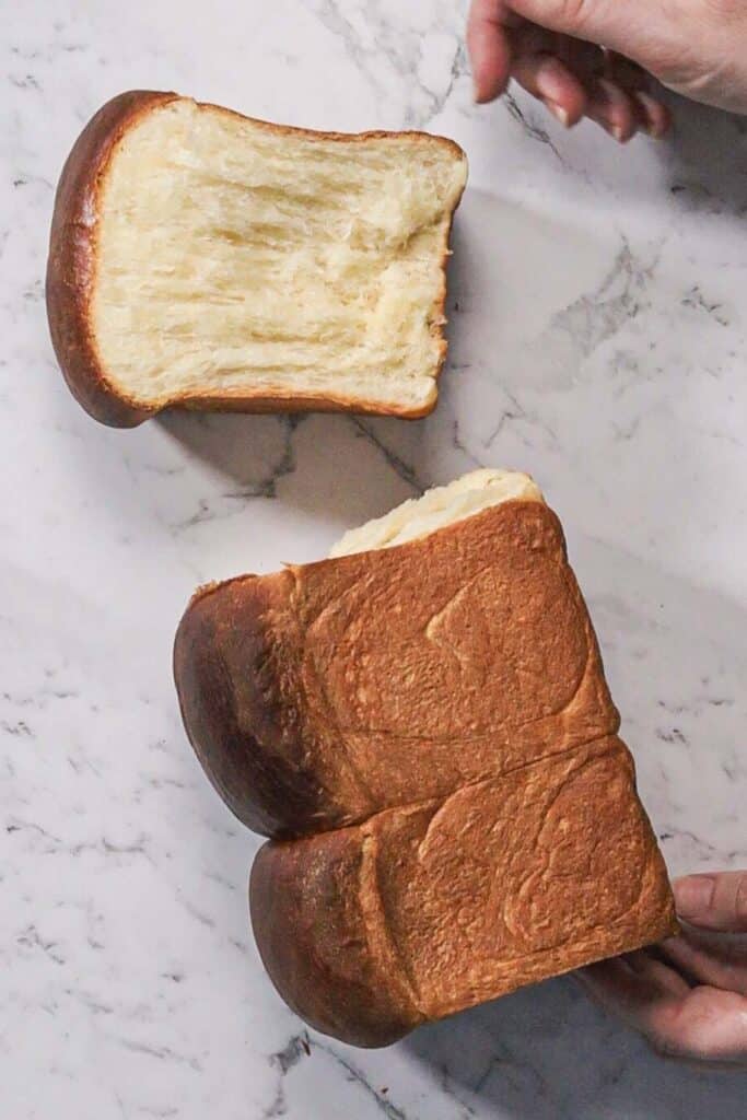 Breaking one part of the bread through a split line