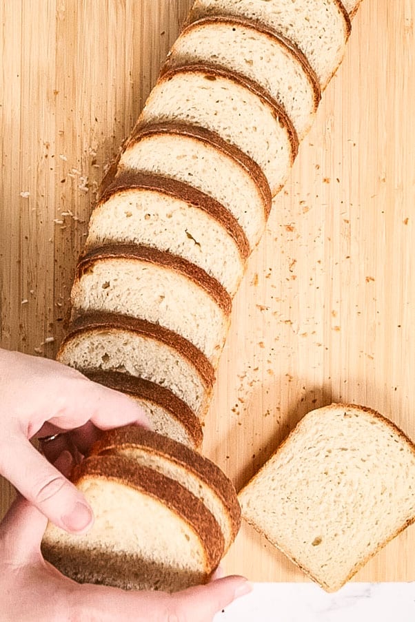 slices of bread laying on top of a wooden chopping board