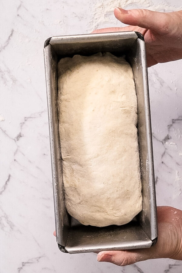 bread dough in a loaf pan ready for baking