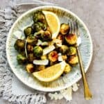 landscape view of fried brussels sprouts in plate with parmesan cheese