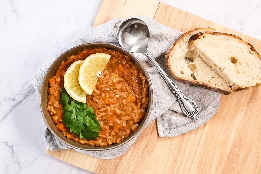 arabic lentil soup with slices of bread and spoon on side