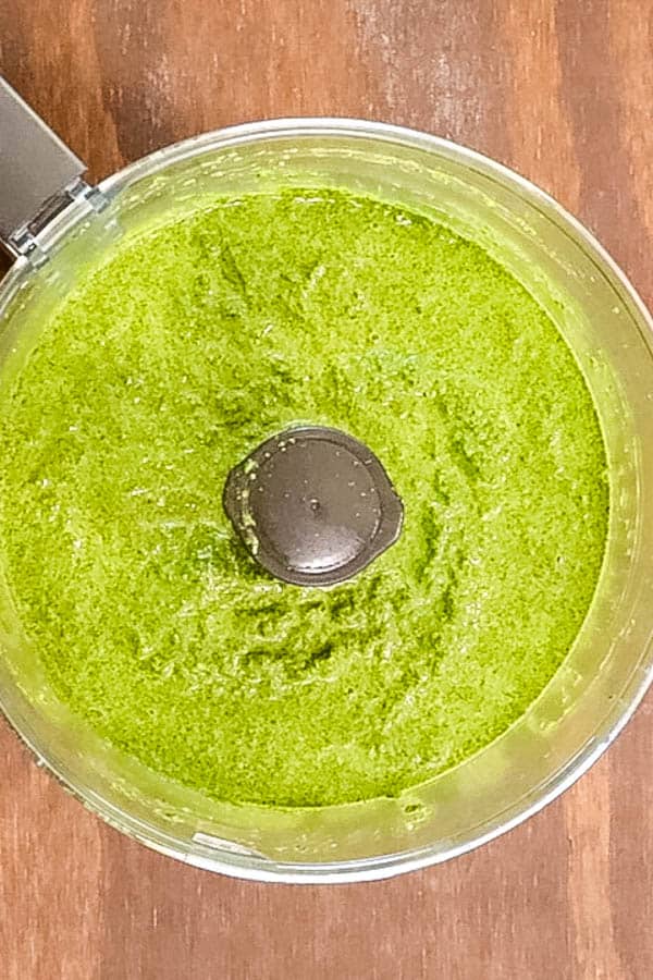 bright green kale sauce in the bowl of a food processor