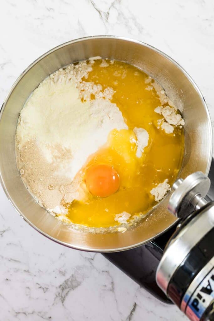 Dough ingredients in a mixer bowl, ready to mix the dough for chocolate milk bread hot cross buns.
