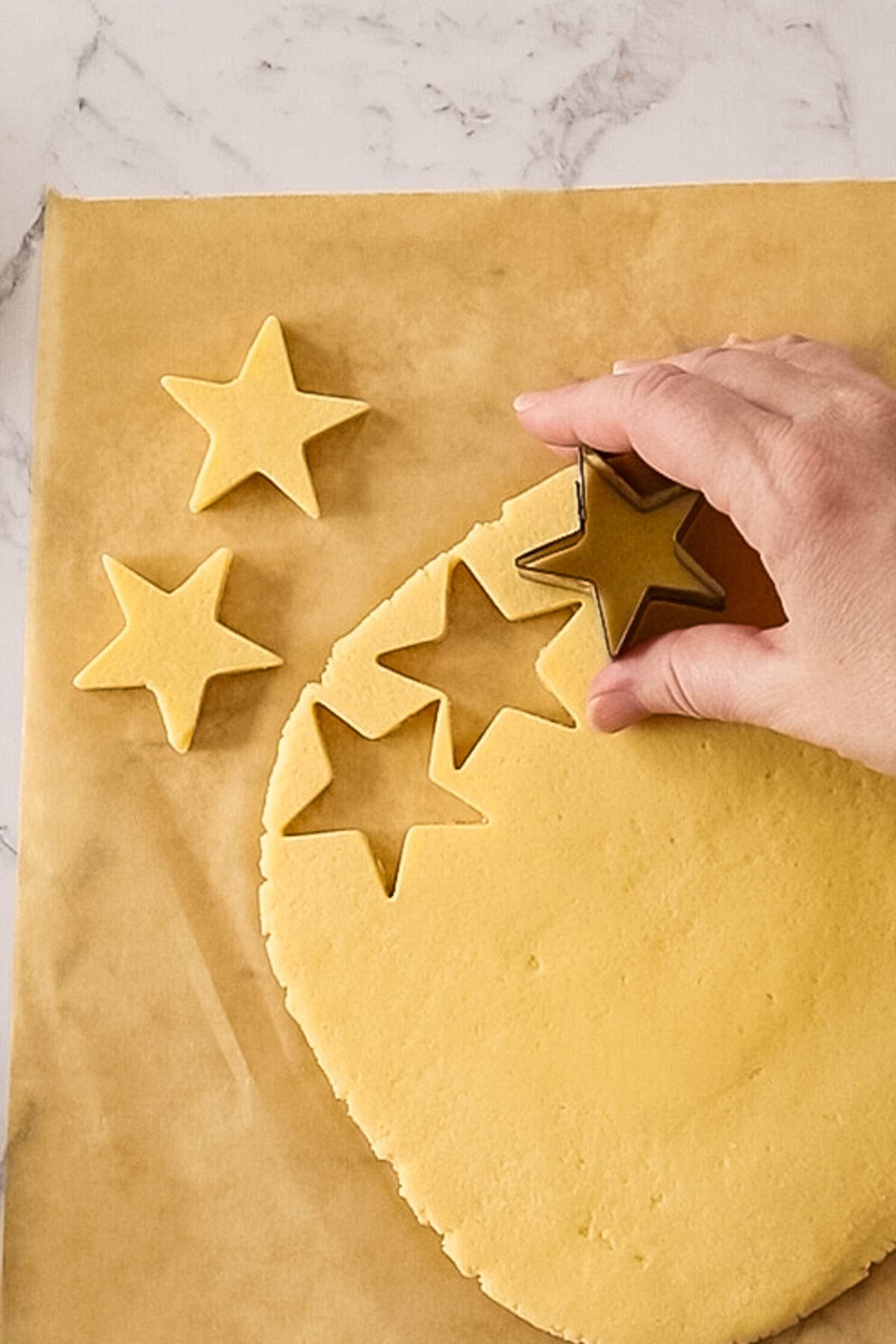 cut outs of star-shaped Christmas butter cookies
