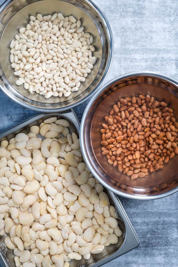 Soaked beans in bowls and a tray, ready to cook in a steam oven.