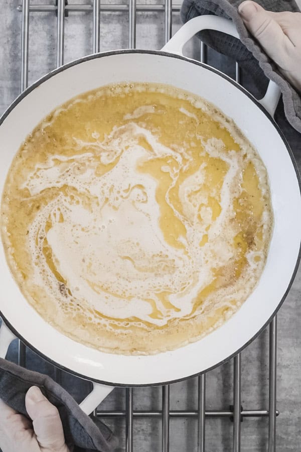 Dutch Baby Pancake batter settling in a hot buttered pan.