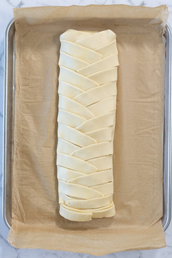 Braided puff pastry filled and ready to bake.