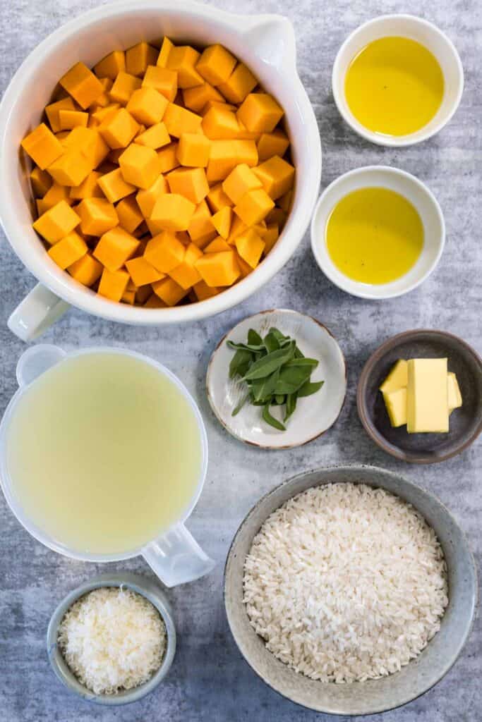 Ingredients for steamed risotto. Pumpkin, olive oil, butter, sage, vegetable stock, rice and parmesan cheese. 