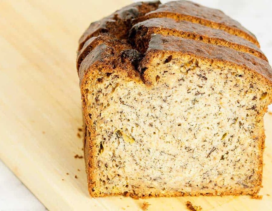 close up image of a slice of banana bread on a wooden board