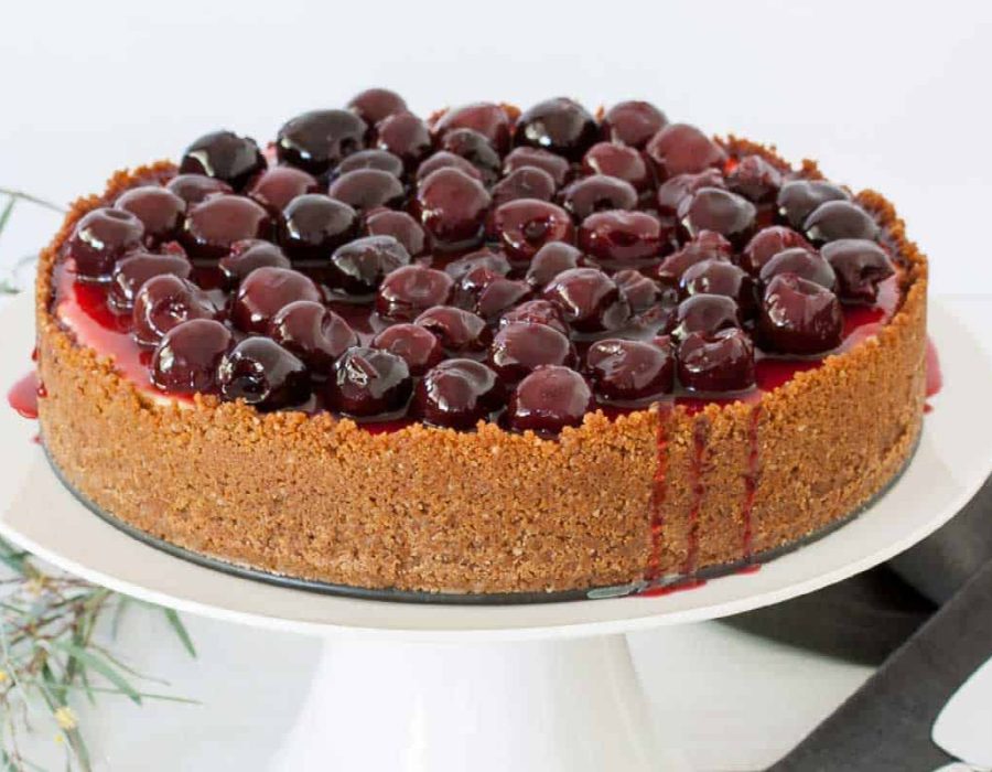 cherry cheesecake with ginger crumb crust and cherry sauce