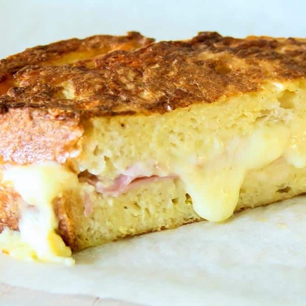 half of a french toast ham and cheese sandwich