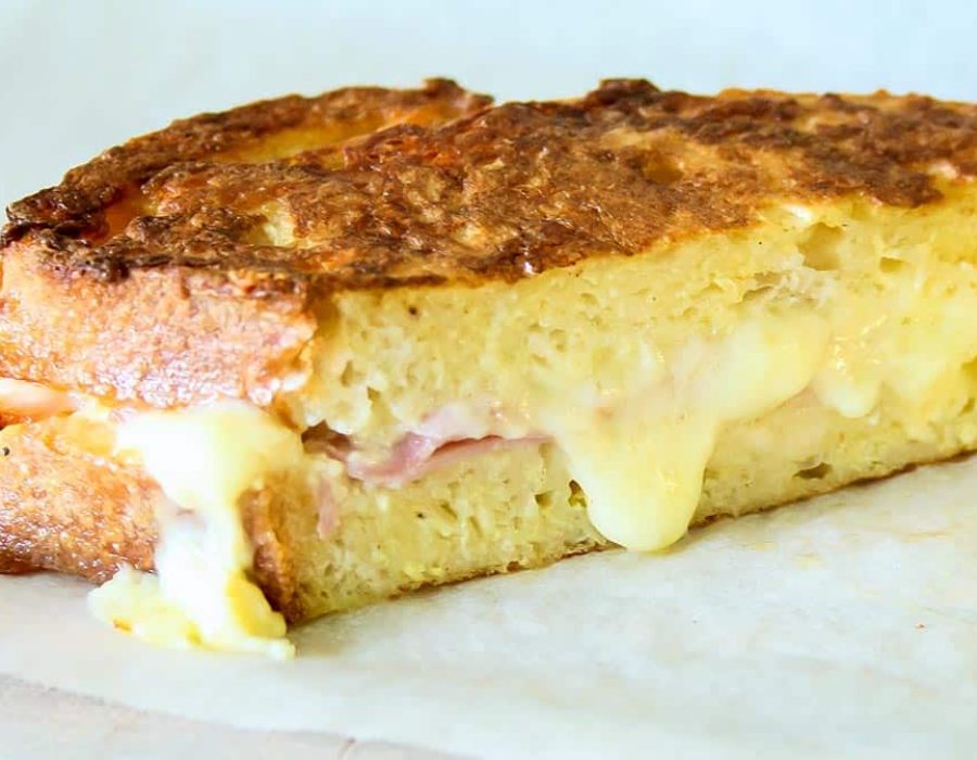 half of a french toast ham and cheese sandwich