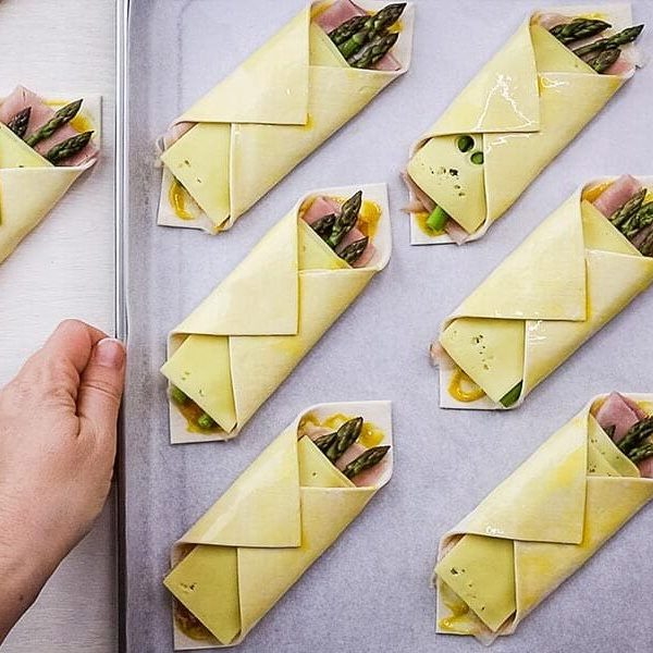 diagonally folded savoury pastries arranged on a tray