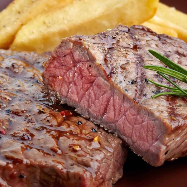 grilled beef steak on wooden cutting board