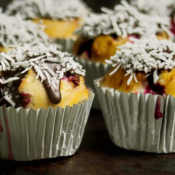 zoomed in image of two muffins of a batch of raspberry Lamington muffins