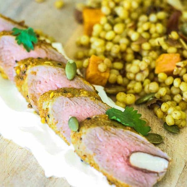 Slices of lamb loin on a bed of yoghurt with Moroccan couscous