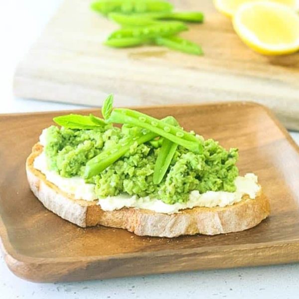 Pea Broad Bean Crostini 1086×675 Web Pea and Fava Bean Crostini on a wooden plate