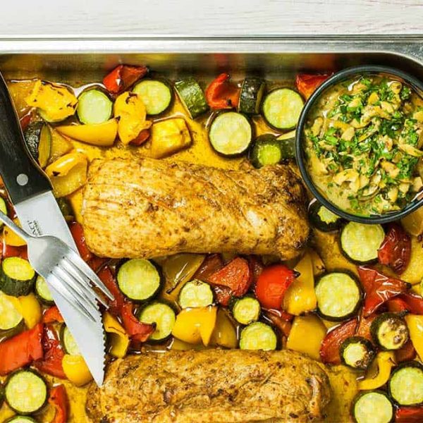 a stainless steel baking dish with pork tenderloin sheet pan dinner