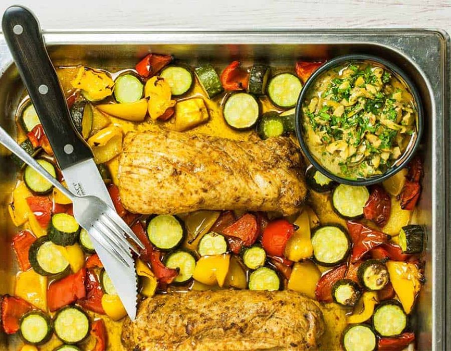 a stainless steel baking dish with pork tenderloin sheet pan dinner