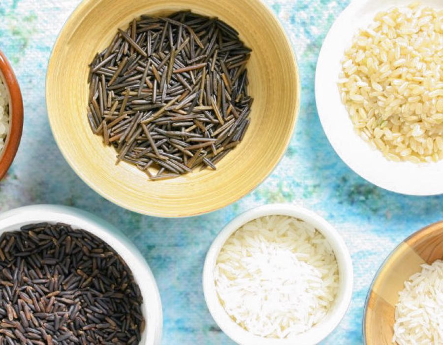 several varieties of uncooked rice in bowls