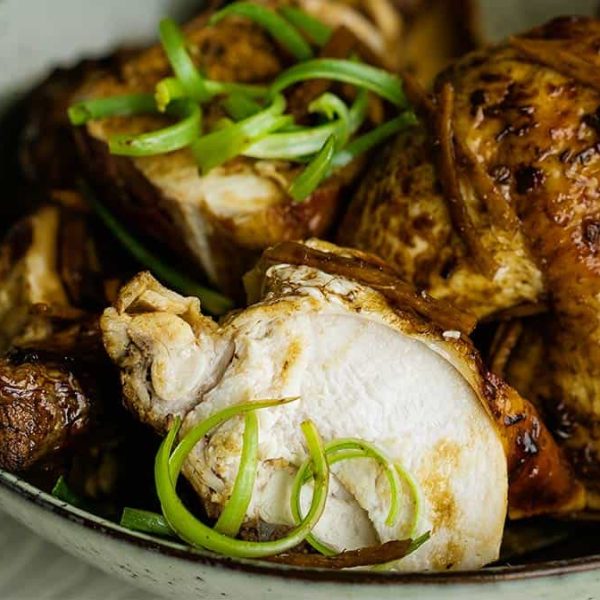 Soy Sauce Chicken Hero Web 1080×675 A close up picture of succulent soy sauce chicken in a grey bowl