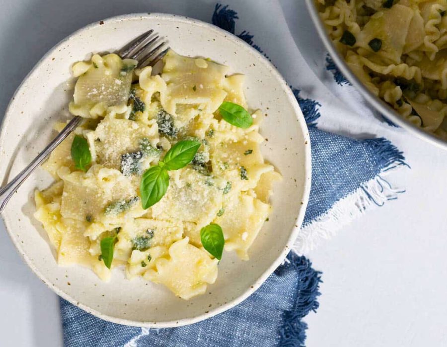 Landscape view of zucchini pasta on a plate under a tablecloth.