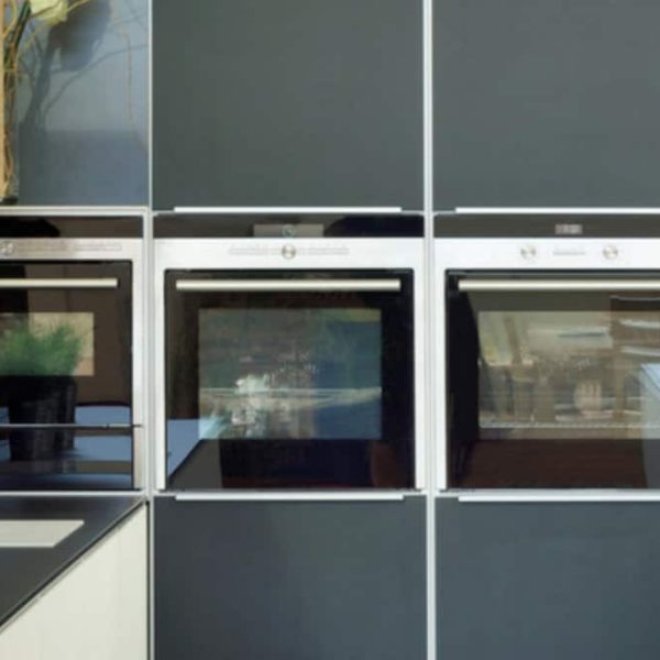 wall of kitchen cabinets with inbuilt ovens