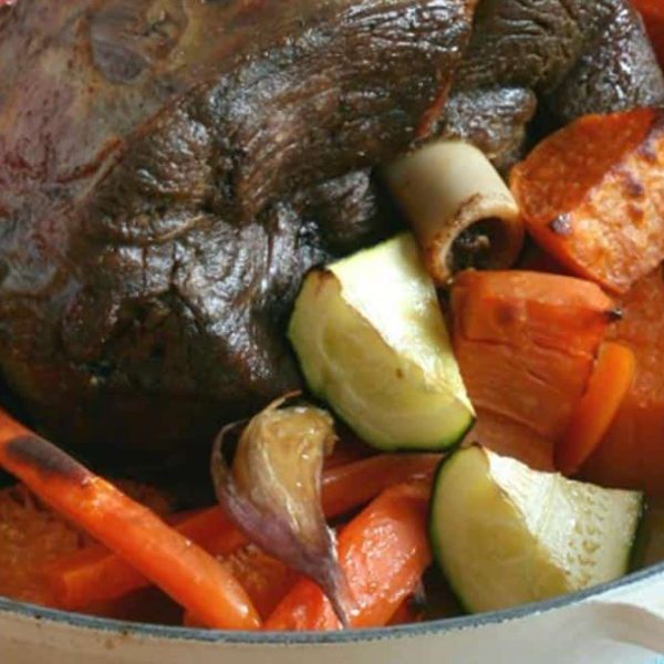 A casserole dish with roast meat and vegetables