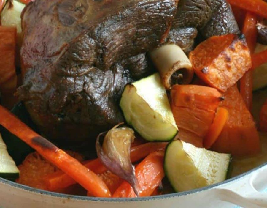 A casserole dish with roast meat and vegetables