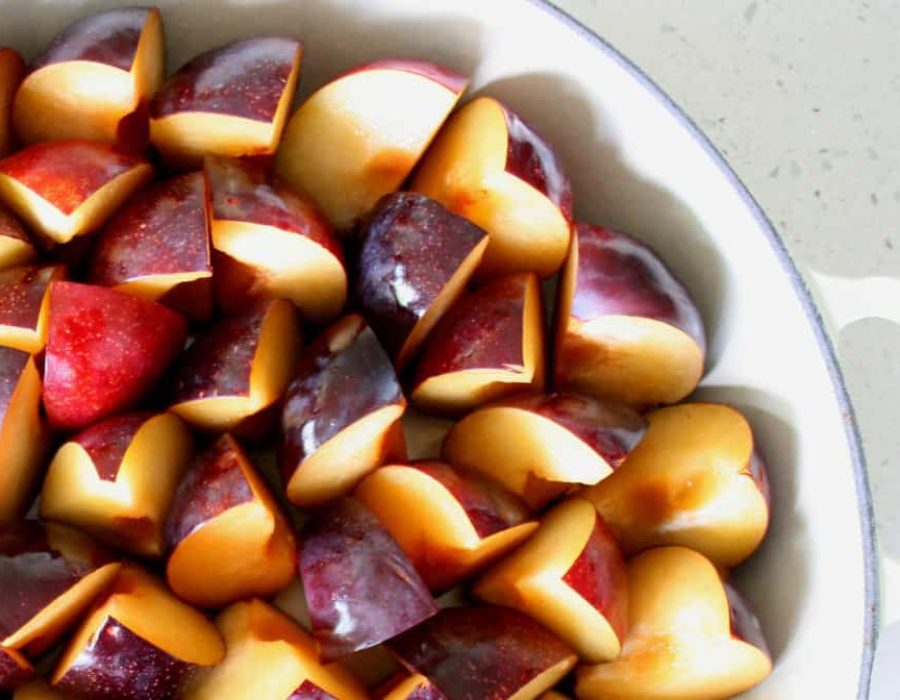 an image of a dish with cut plums waiting to be roasted